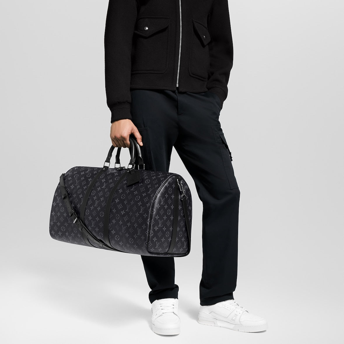 Athena™ Louis Vuitton Keepall Bandoulière 55 duffel bag with monogram canvas, leather trim, and adjustable shoulder strap.
