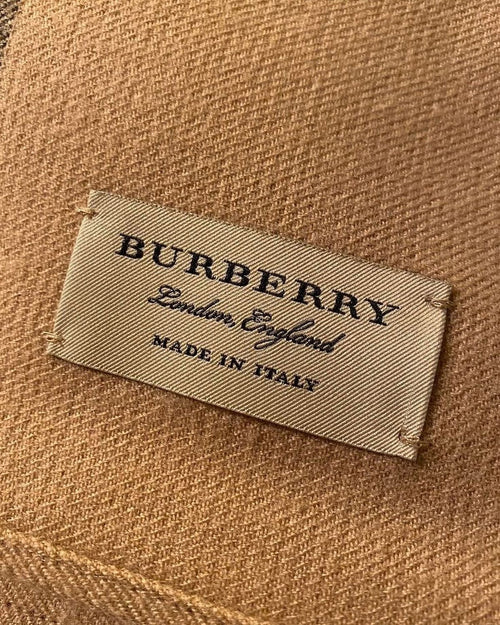Athena Burberry zipper showing a metallic zipper with branded pull tab and fabric surrounding it in a close-up view.
