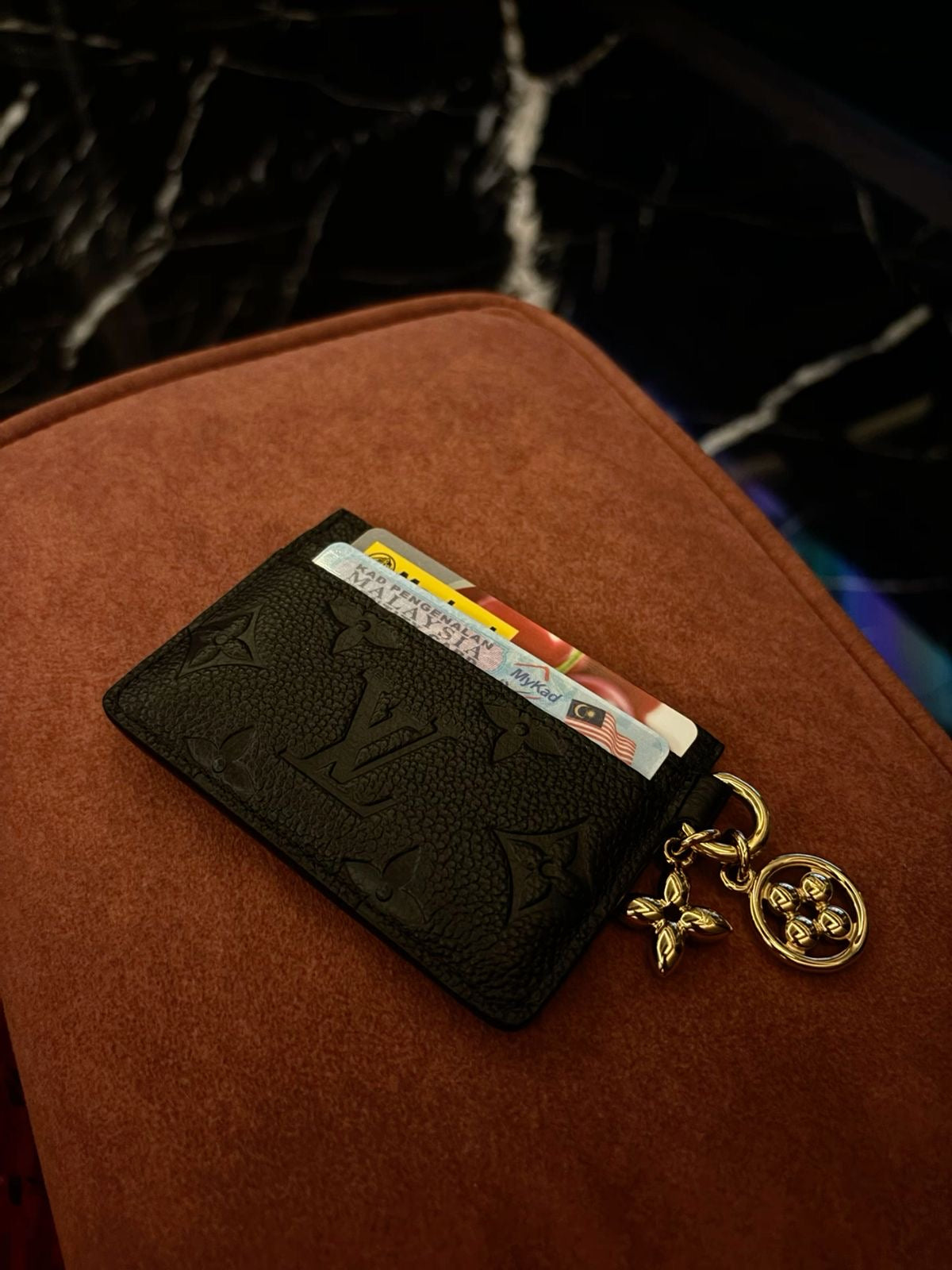 Athena LV cardholder with multiple card slots, crafted from sleek leather, showing detailed stitching and compact design.