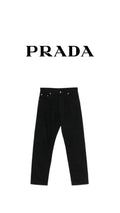 Athena™ Prada black stack jeans laid flat, showing slim fit and stacked leg design, made from denim fabric.