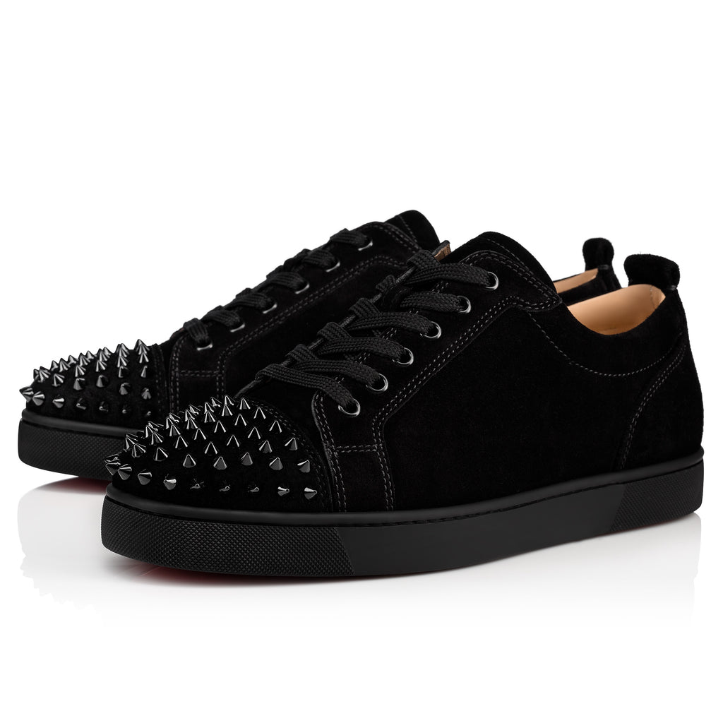 Christian Louboutin junior footwear by ATHENA ™, featuring stylish design and signature red sole in a close-up image.