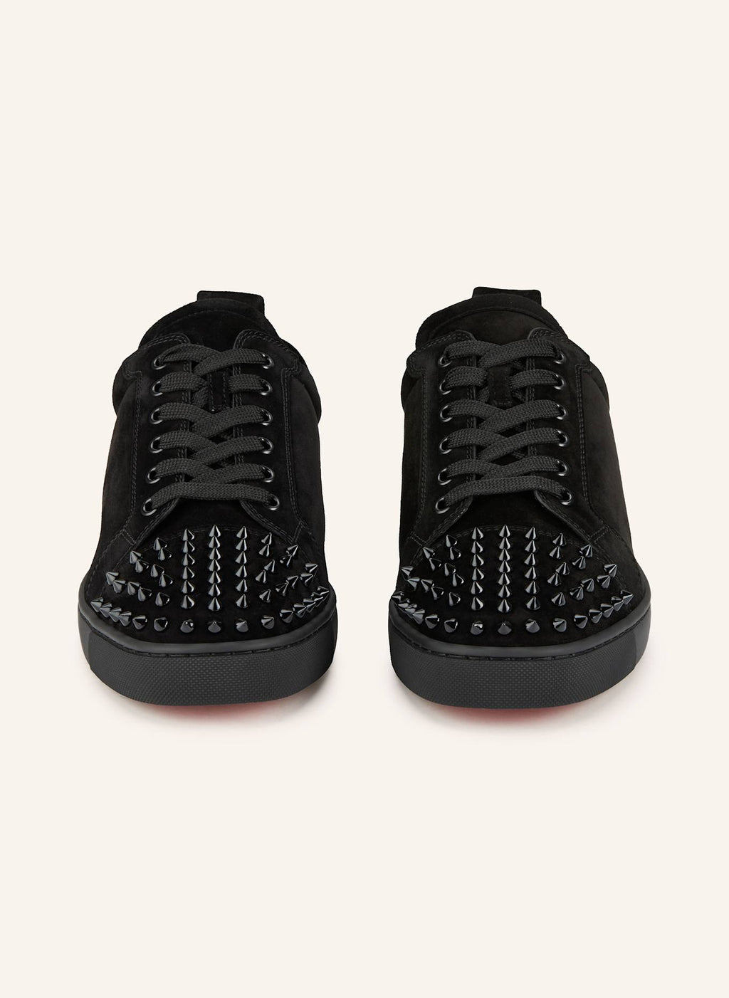 Christian Louboutin Junior sneakers by ATHENA ™ featuring red soles and stylish design, showcased in a close-up image.
