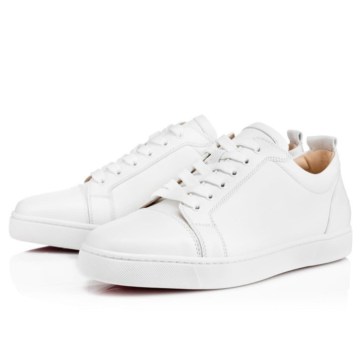 Christian Louboutin junior sneakers by ATHENA ™, featuring red sole, sleek design, and stylish black leather uppers.