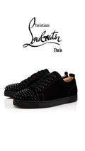 Christian Louboutin Junior shoes by ATHENA™ featuring signature red soles and stylish design, shown on a clean surface.