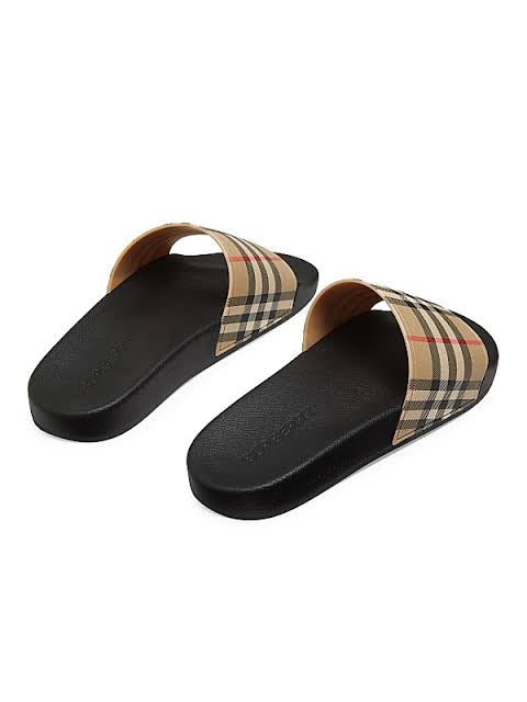 Athena™ Burberry slippers with beige and black check pattern, plush fabric, and slip-on style, displayed on a neutral background.