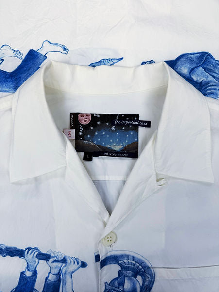 Athena™ Prada Important Ones button-up shirt in classic design, featuring a crisp collar and front buttons, displayed on a hanger.